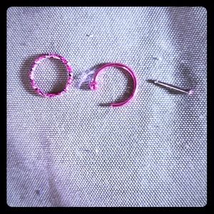 2 nose rings and one nose stud, one lip stud